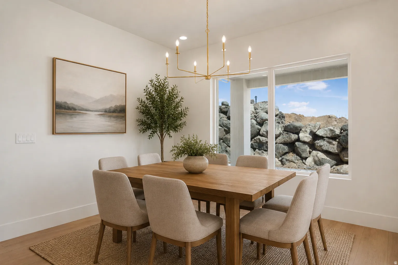 Dining area featuring wood-finish flooring and a contemporary linear chandelier