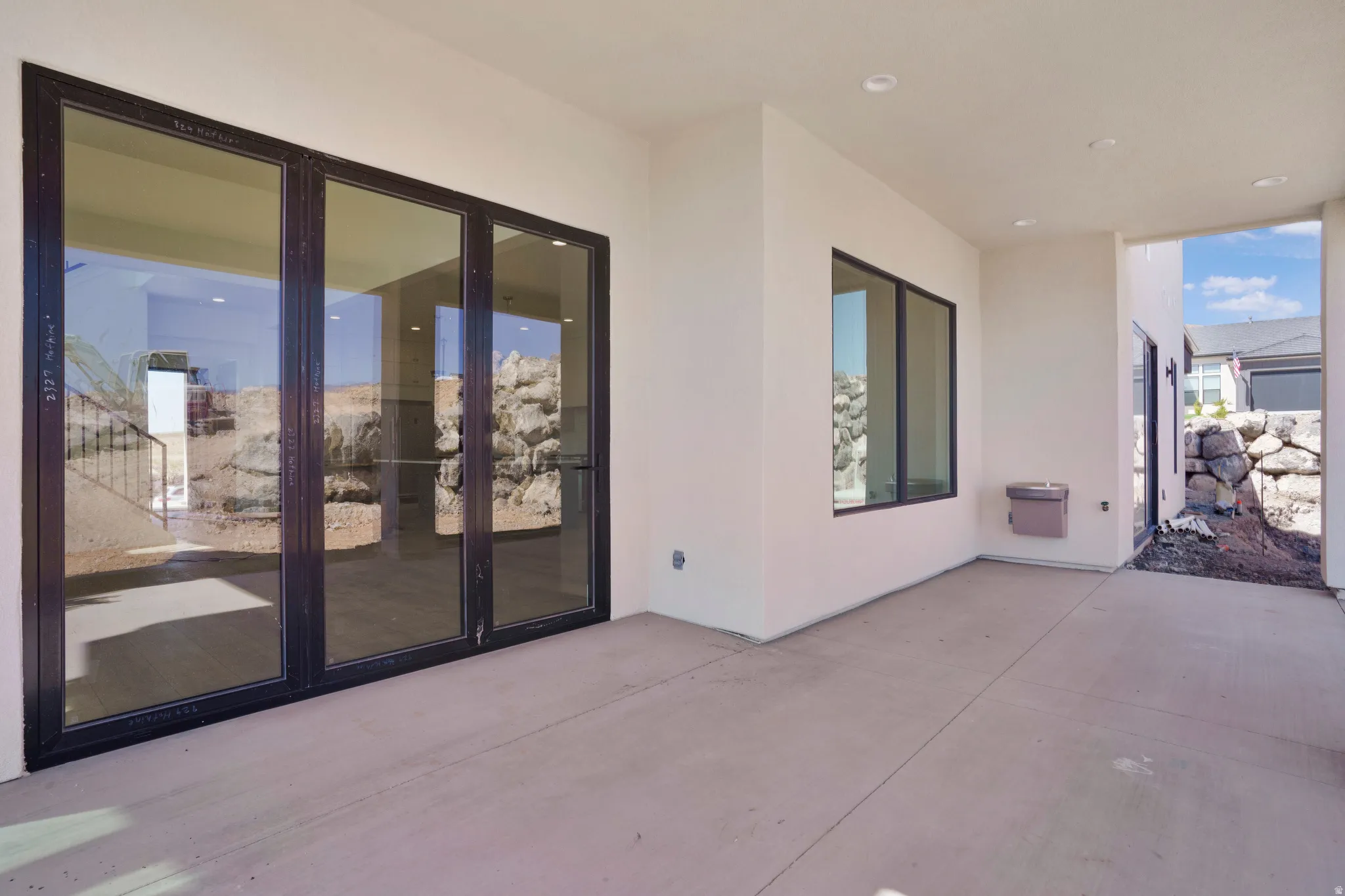 Expansive covered patio featuring a smooth concrete surface and recessed lighting