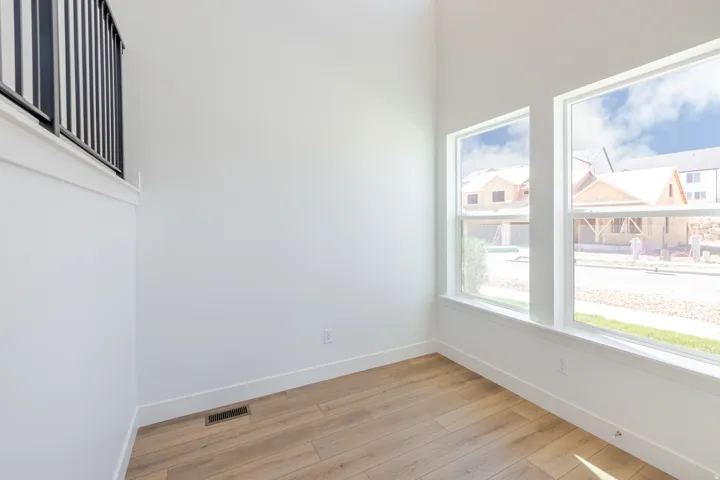 Light wood-finish flooring with white trim