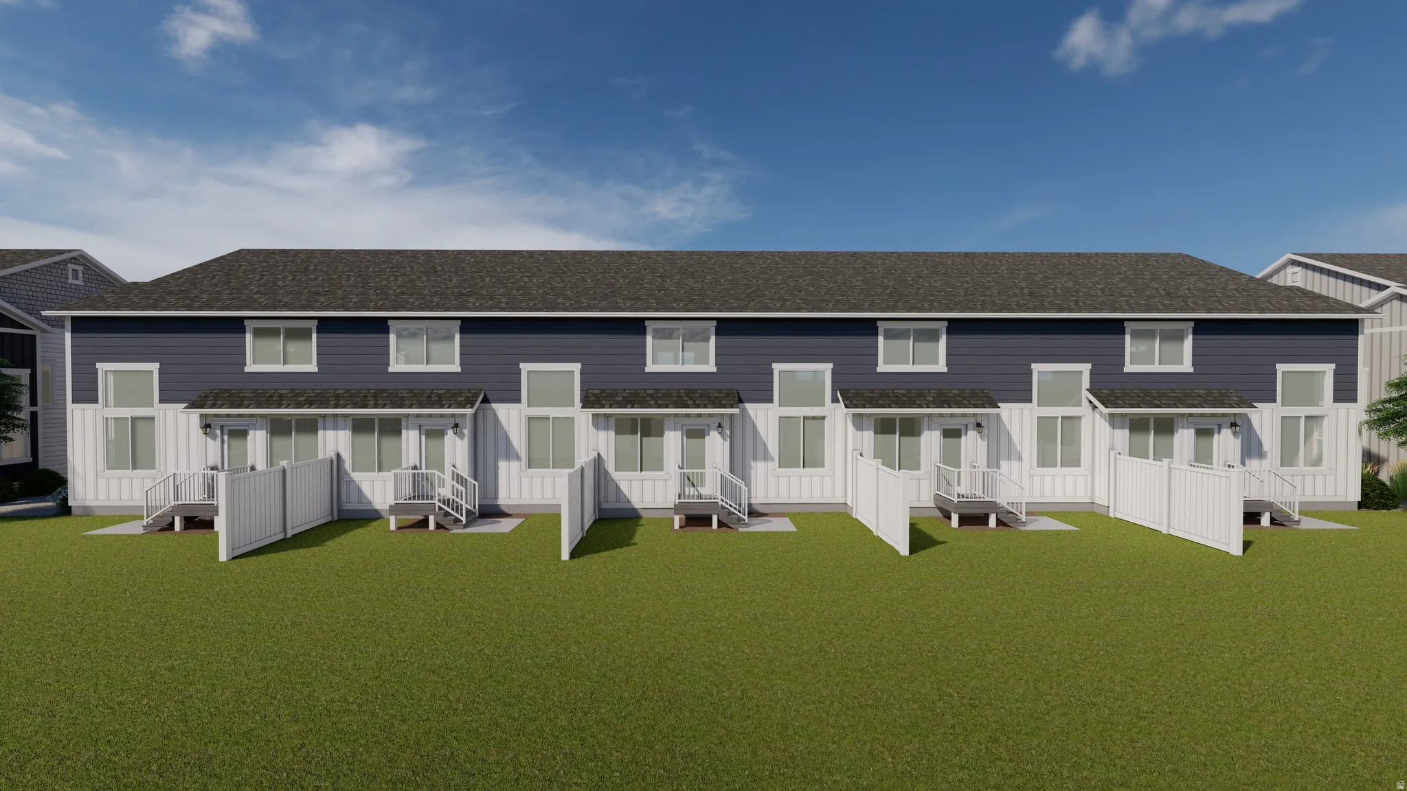 Rear exterior of a multi-unit property featuring a dark shingle roof, dark blue horizontal siding, and white vertical siding
