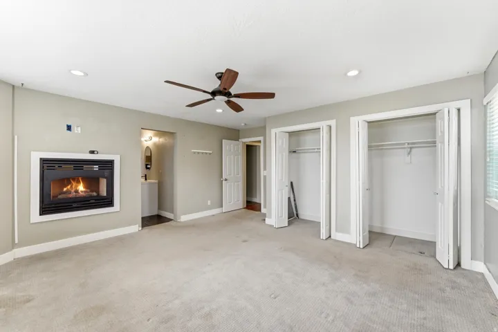 Spacious interior featuring neutral wall tones, recessed lighting, and a ceiling fan