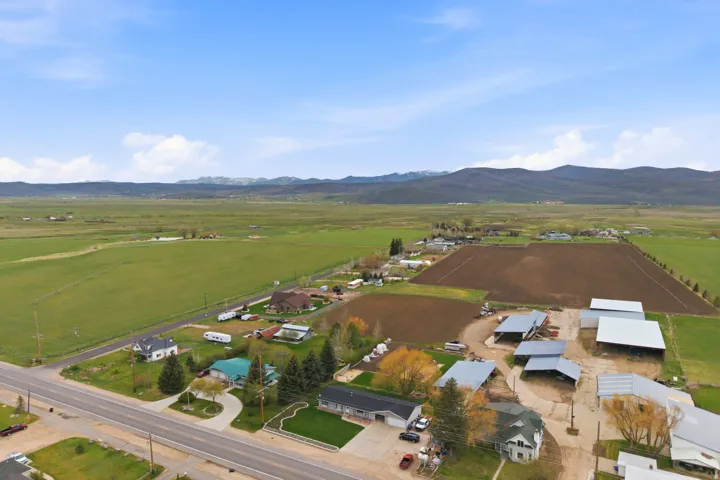 Expansive agricultural land featuring a mix of cultivated fields and green pastures