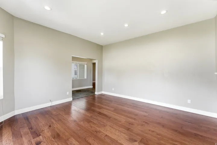 Spacious interior featuring wood-finish flooring, recessed lighting, and light-toned walls