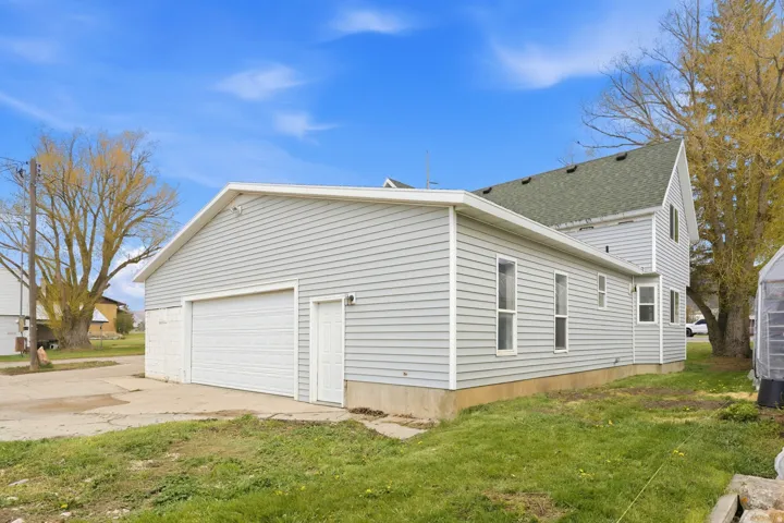 Light gray vinyl siding exterior with a pitched roof
