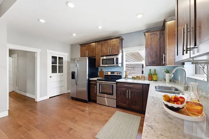 Kitchen featuring wood-finish flooring, recessed lighting, and light blue walls