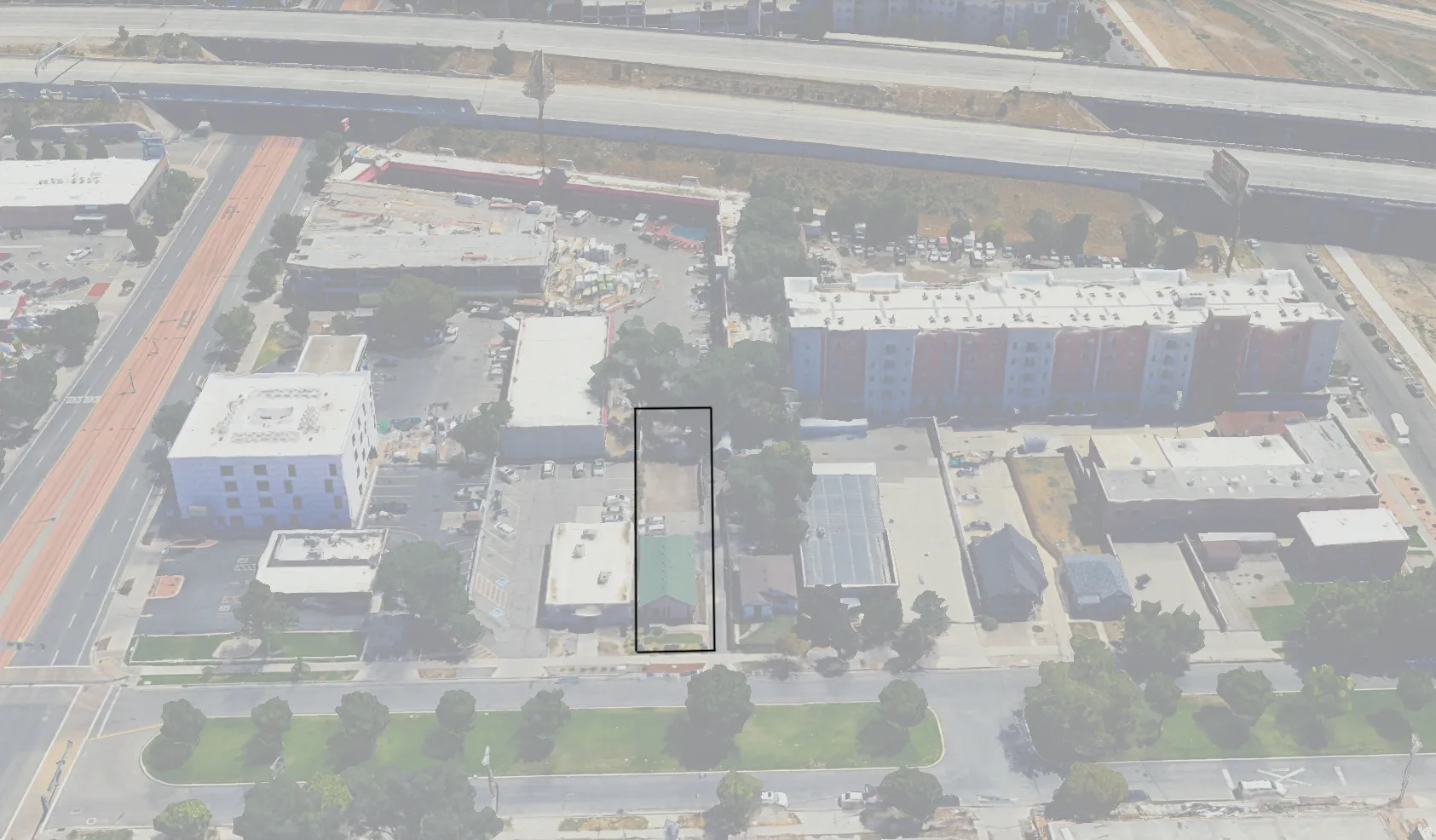 Aerial overview showcasing a rectangular parcel with a green-roofed structure