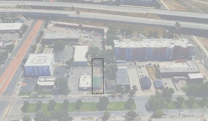 Aerial overview showcasing a rectangular parcel with a green-roofed structure