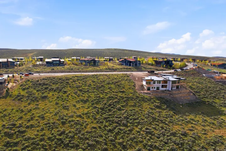 Developing hillside residential area featuring a partially constructed contemporary residence