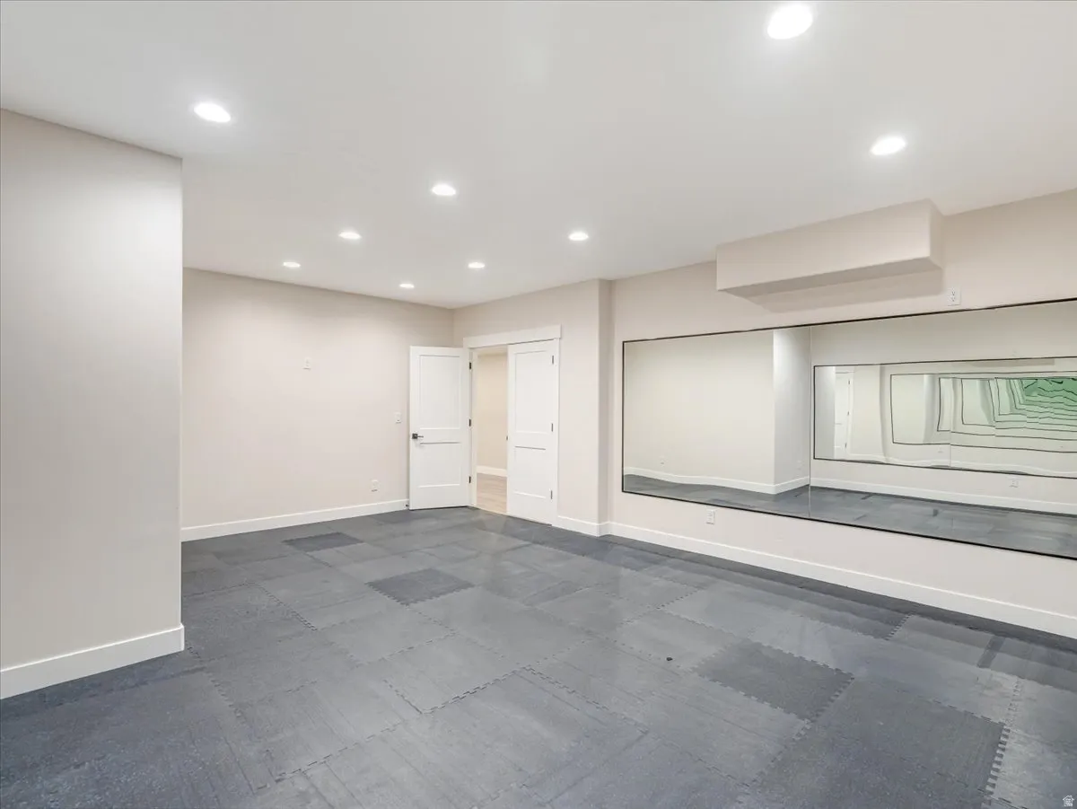 Dedicated studio space featuring full-wall mirrors and cushioned flooring