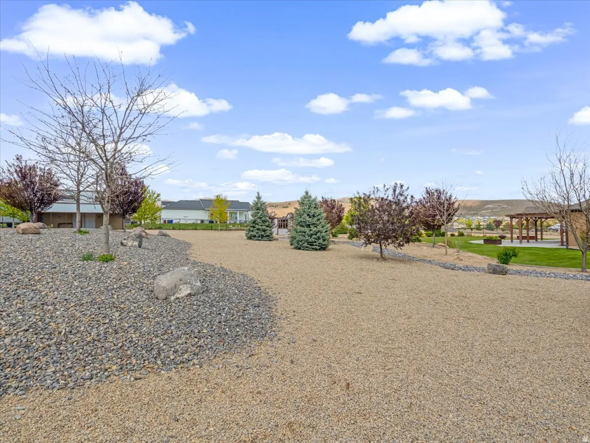Expansive outdoor space featuring a combination of gravel and stone landscaping