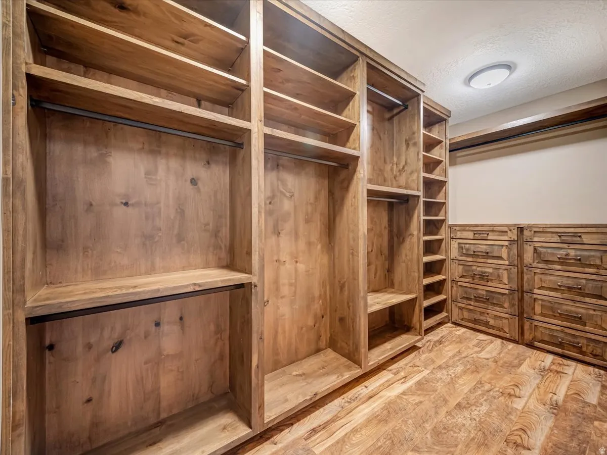 Custom wood-finish closet system featuring integrated shelving and hanging rods
