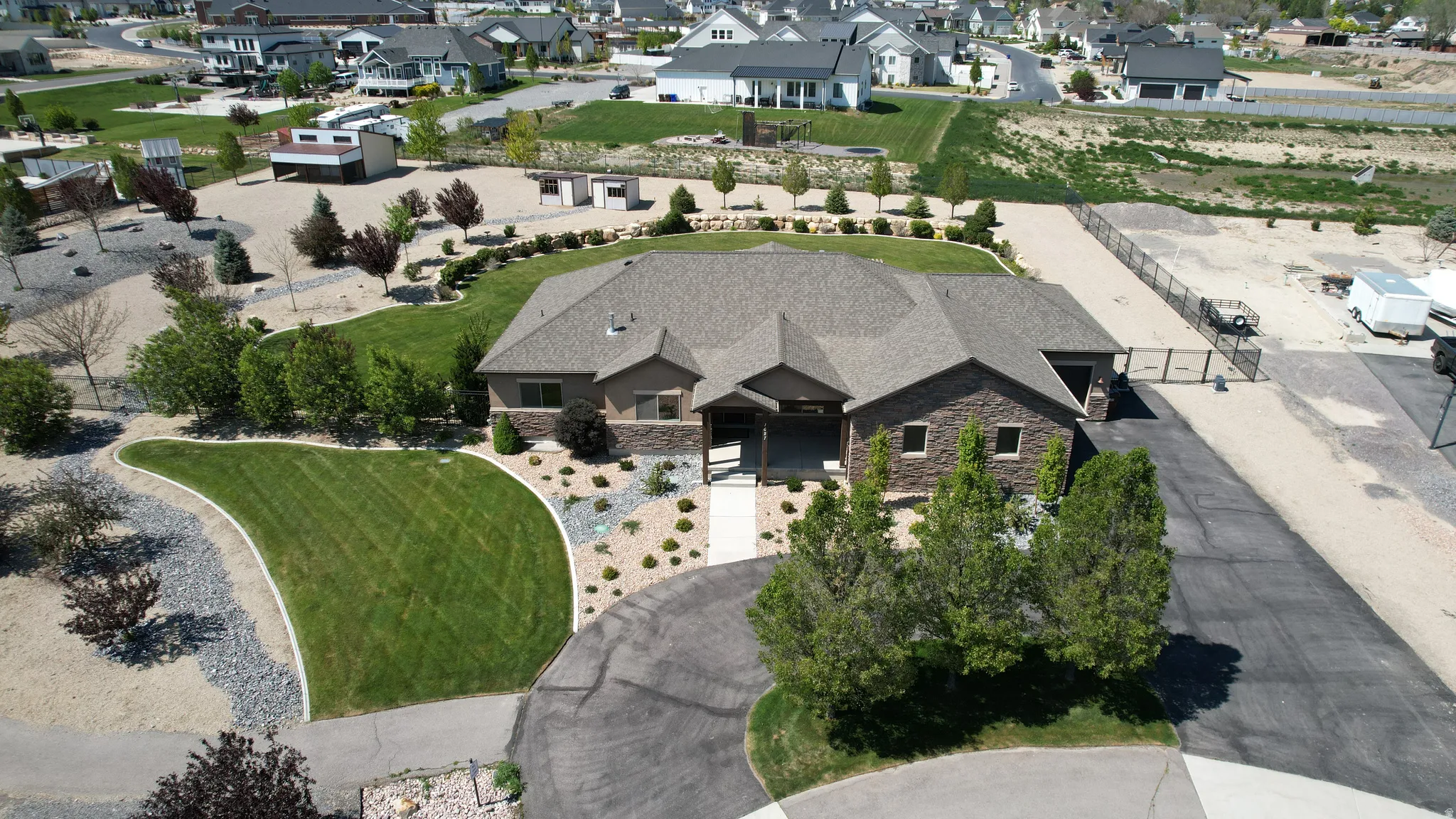 Ranch-style residence featuring a stone and stucco exterior with a multi-gabled roof