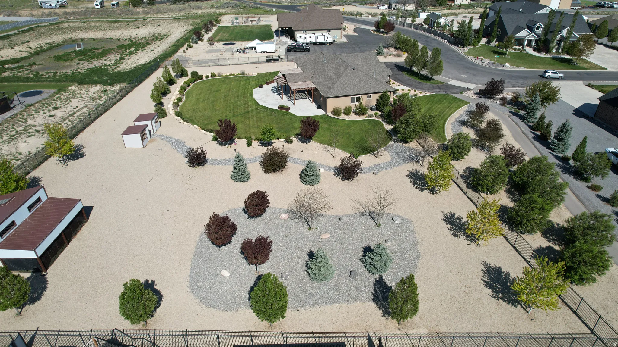 Expansive property featuring a tan gravel landscape and a central island of decorative grey gravel