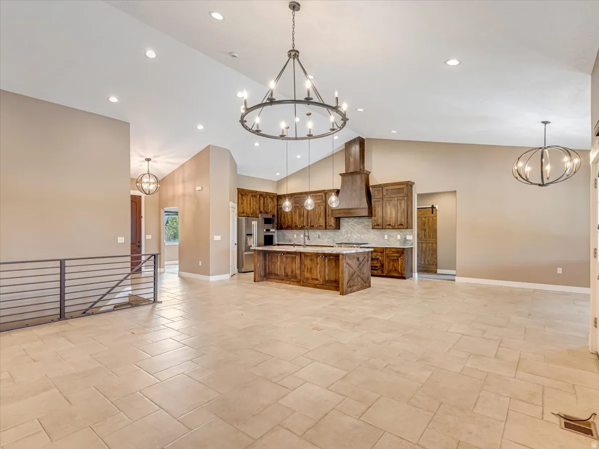Spacious open-concept living area featuring a kitchen with custom wood cabinetry and a central island