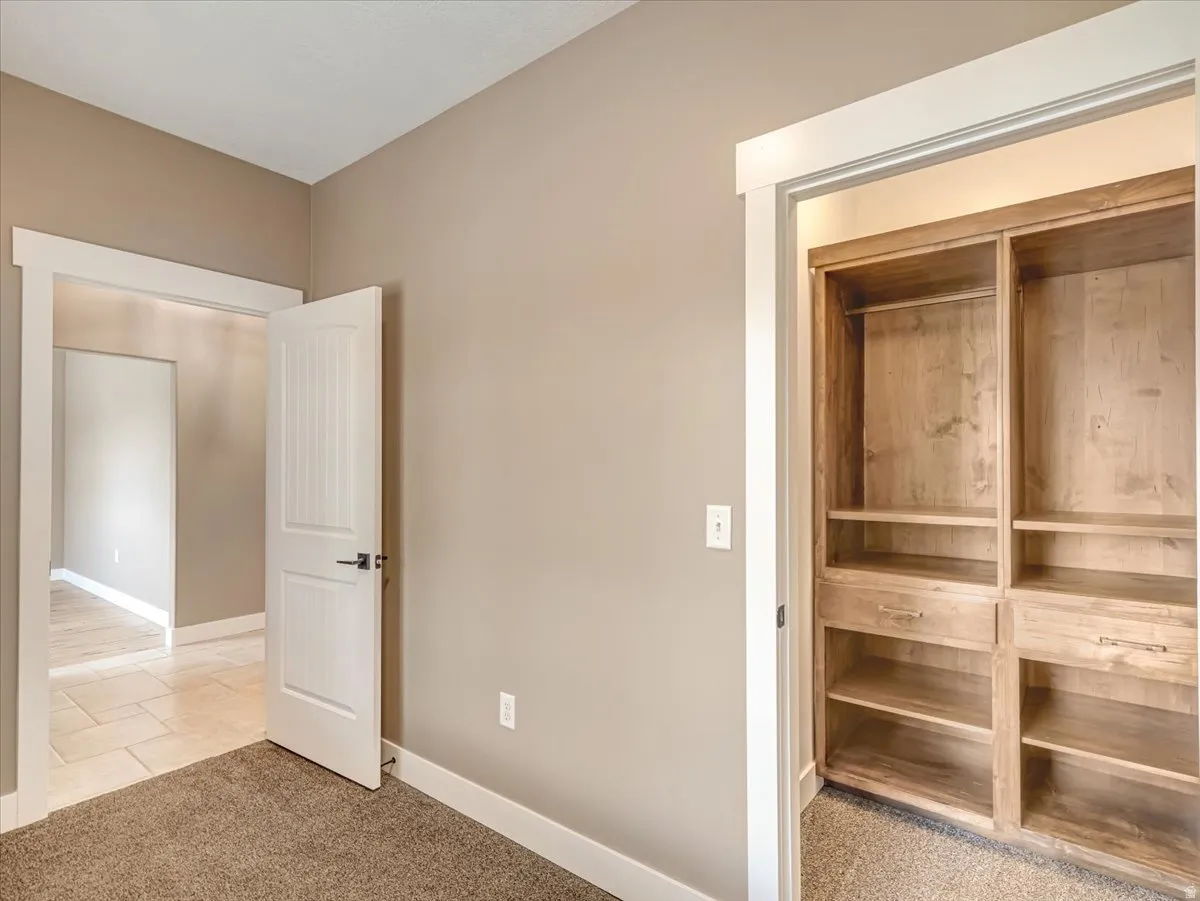 Built-in wood-finish closet shelving with integrated drawers