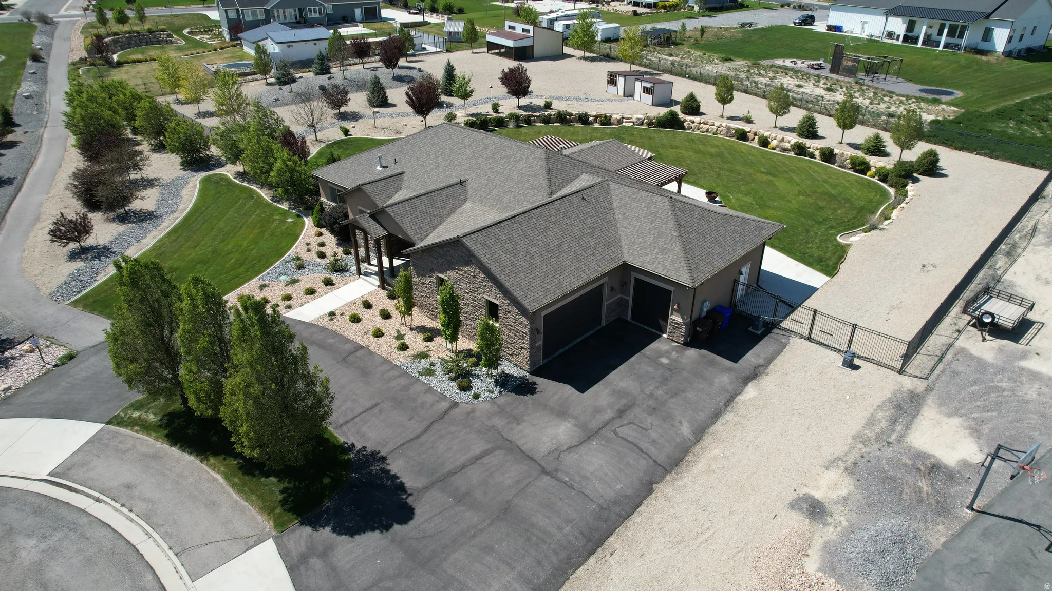Single-story residence featuring a stone and stucco exterior with a dark shingle roof