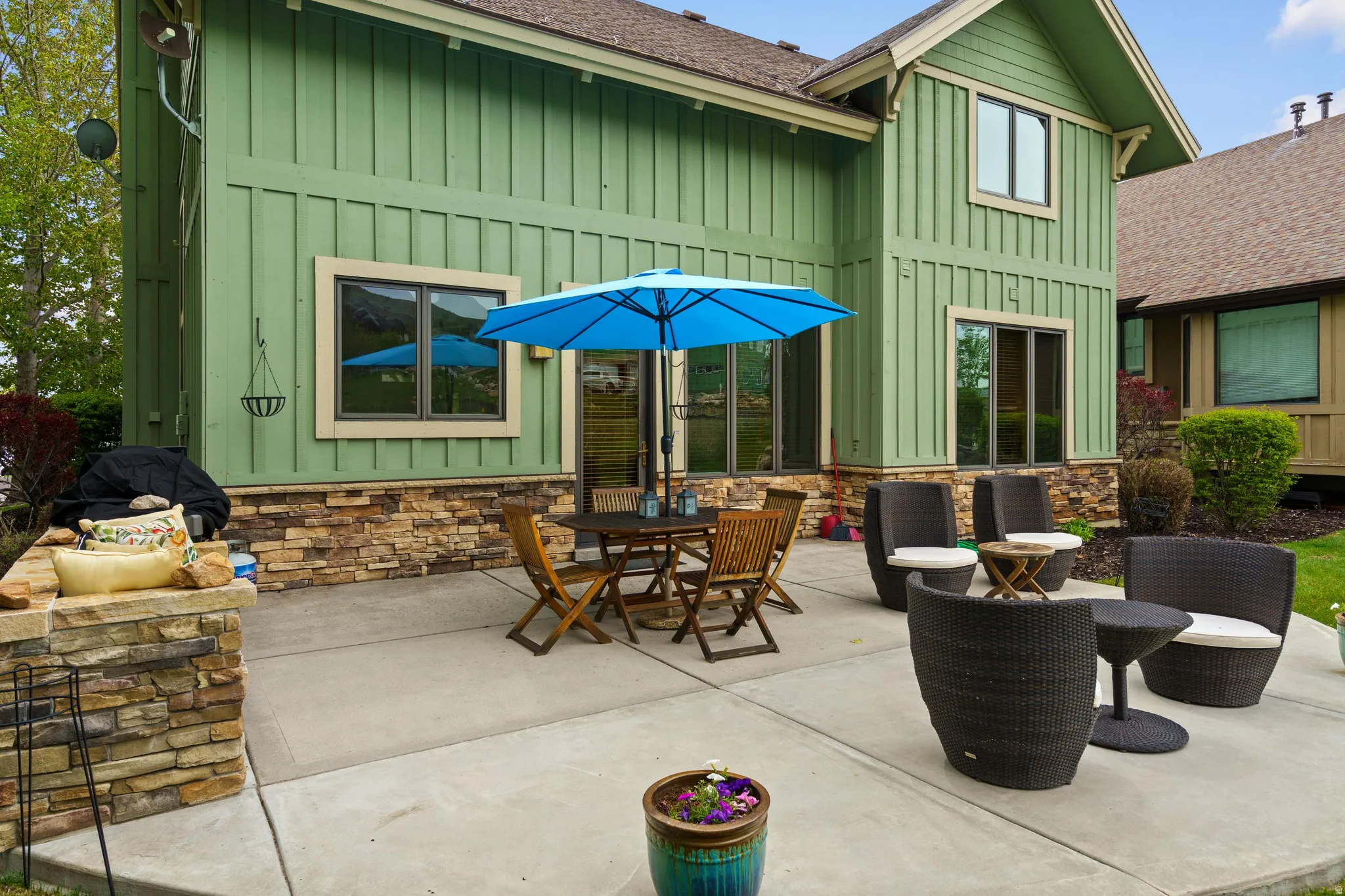 Expansive concrete patio offering multiple seating areas