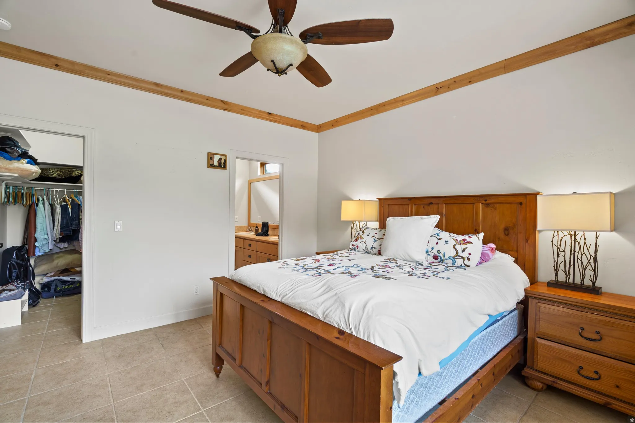 Bedroom featuring wood-finish ceiling trim, a ceiling fan, and tiled flooring