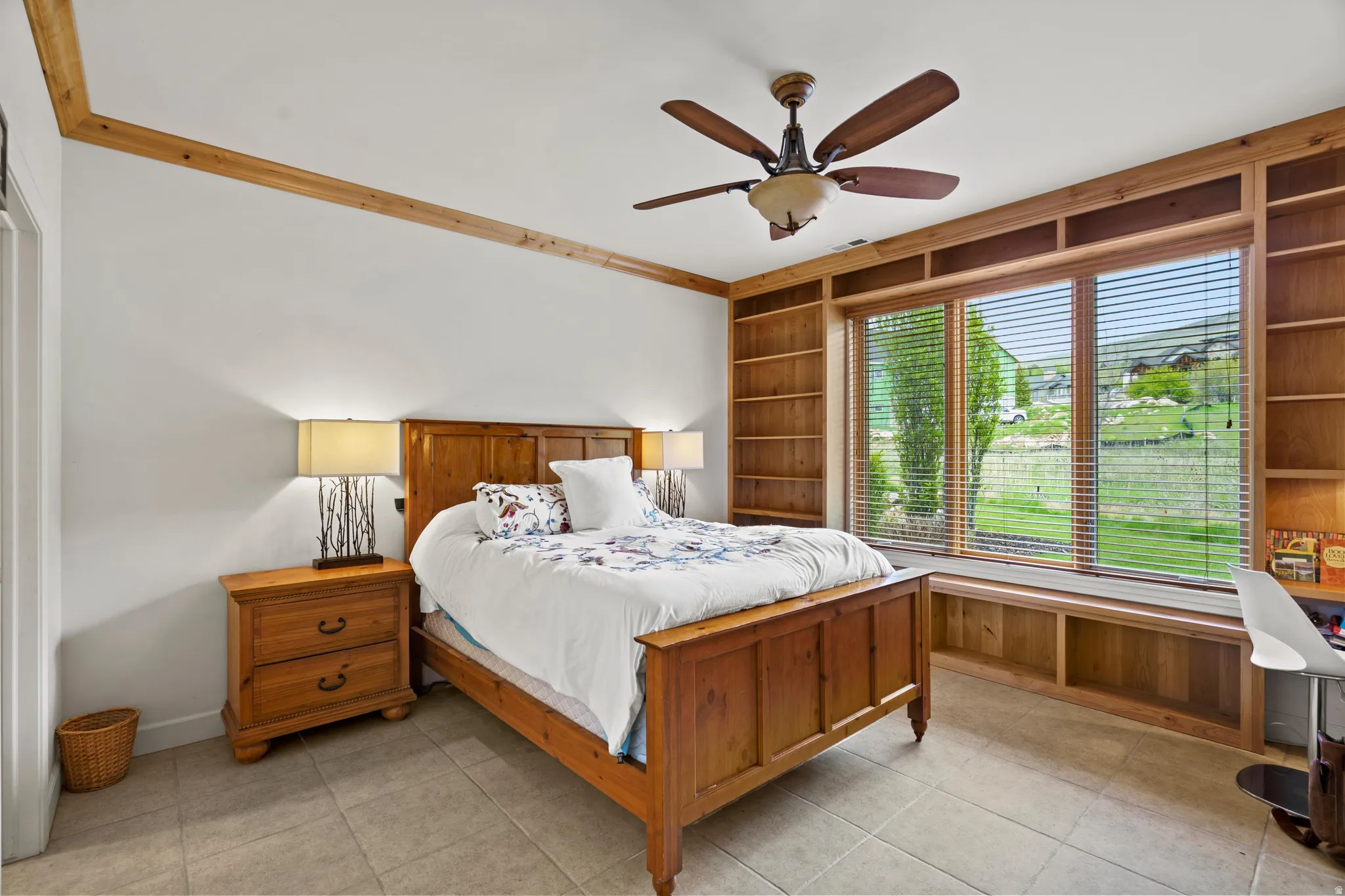 Expansive window featuring integrated wood-finish shelving and a window seat