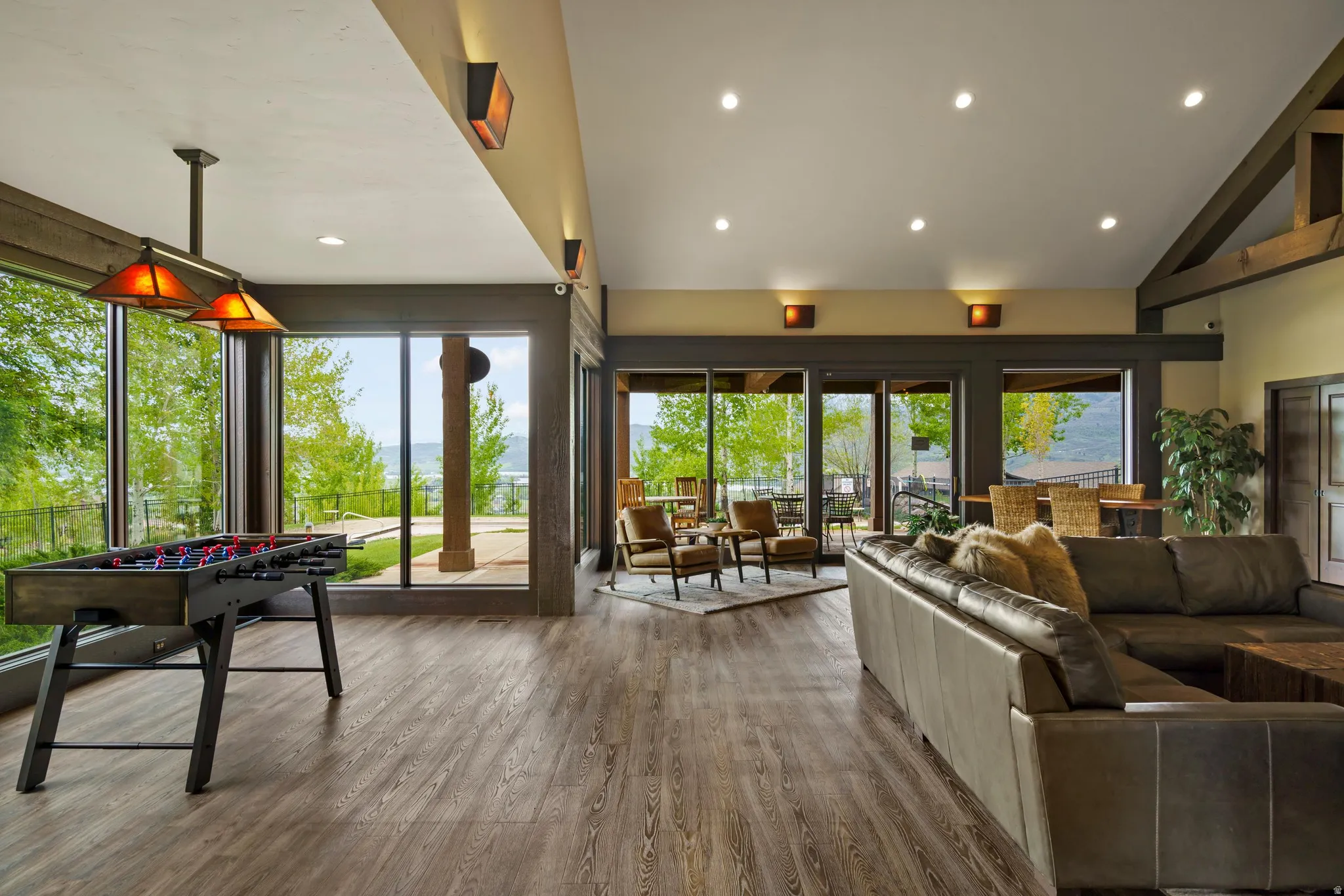 Open-concept interior featuring wood-finish flooring, recessed lighting, and expansive windows
