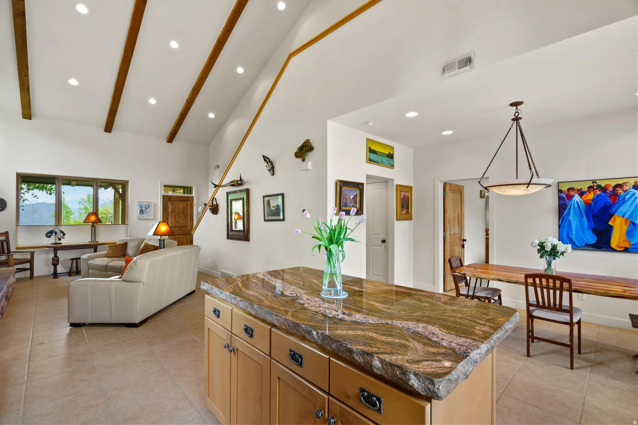 Vaulted ceiling featuring exposed wood beams and recessed lighting