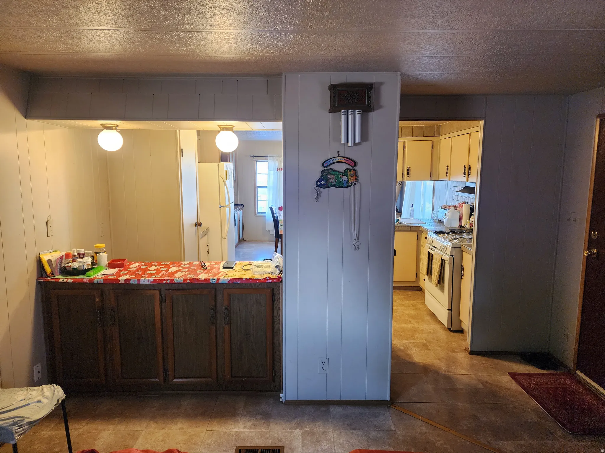 Kitchen pass-through window with built-in dark wood-finish cabinetry