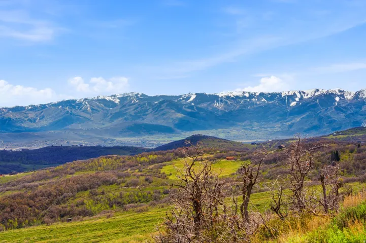Expansive mountain scenery featuring snow-capped peaks in the distance