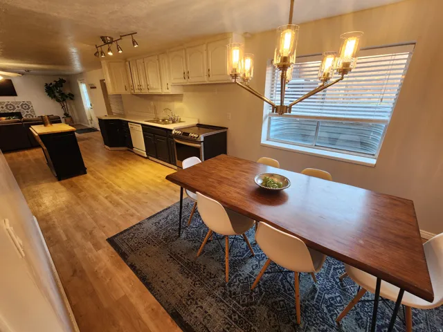 Open-concept living space with wood-finish flooring extending into the kitchen