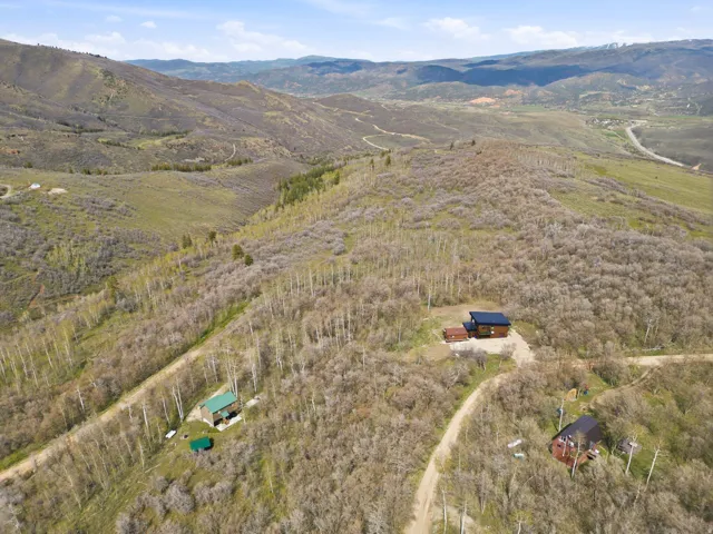 Expansive mountainous terrain featuring multiple structures and natural landscapes