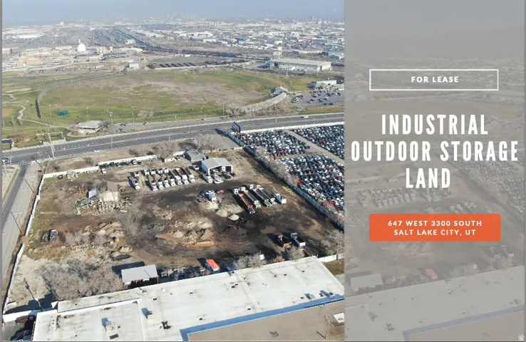 Expansive industrial outdoor storage land featuring perimeter fencing, multiple structures, and gravel surfacing