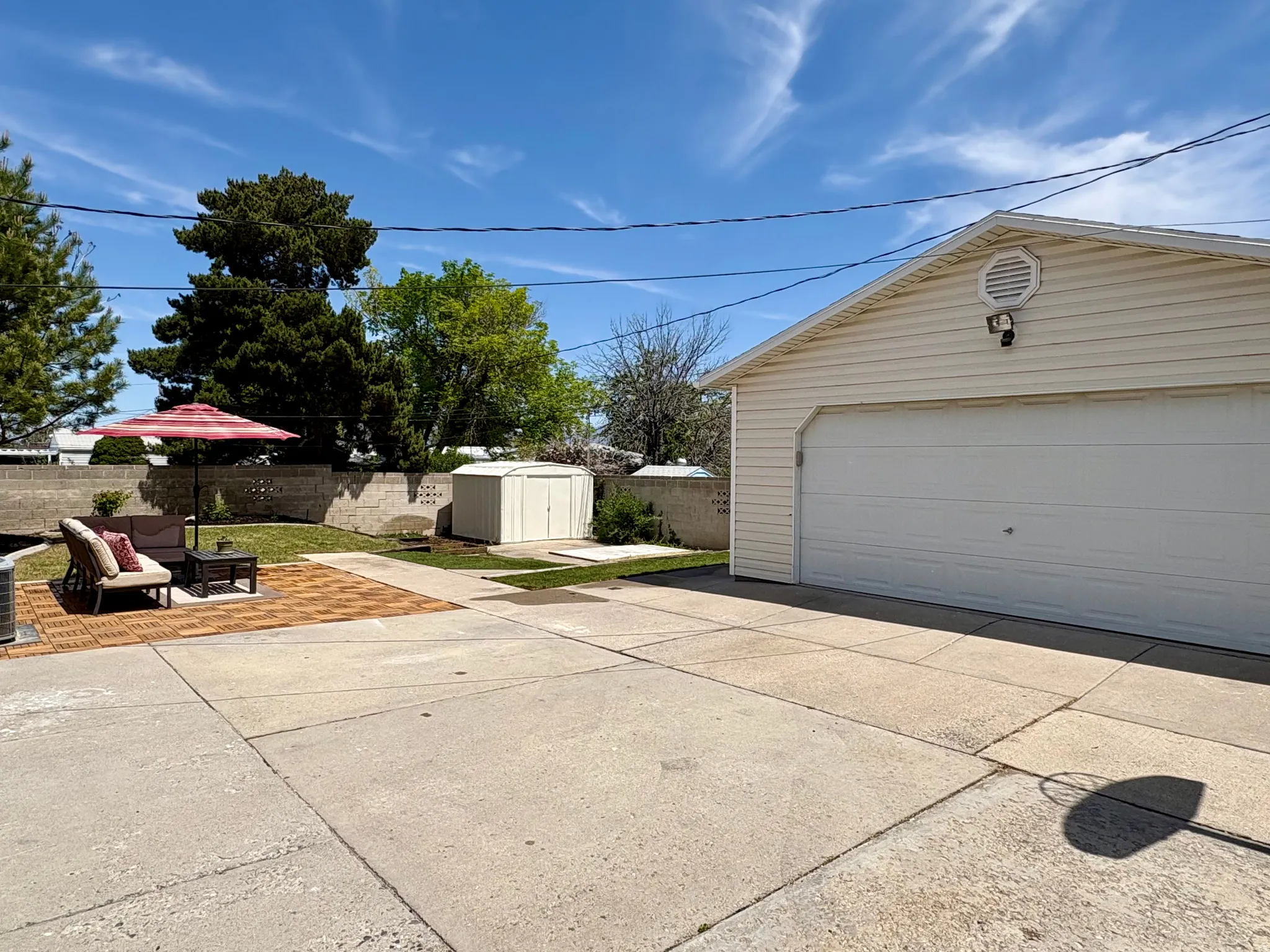 Detached two-car garage with vinyl siding and a gable vent