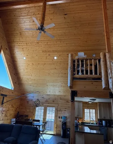 Vaulted ceilings featuring natural wood paneling and exposed beams
