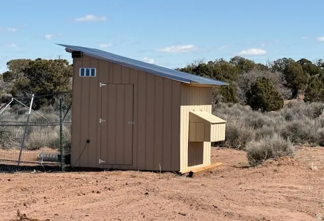 Freestanding outbuilding with a sloped metal roof and solar panel array