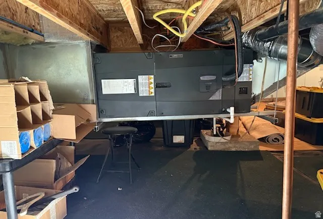 Utility area featuring an HVAC system, exposed ceiling joists, and visible ductwork