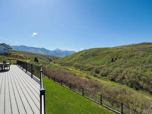 Expansive outdoor deck with composite decking and black metal railings
