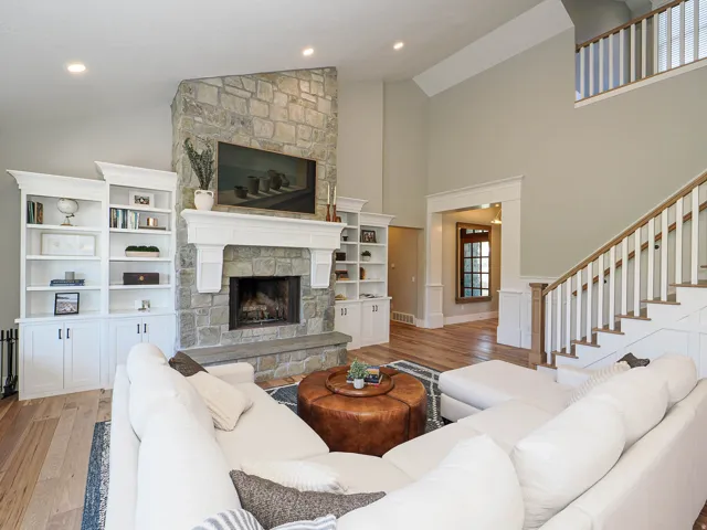 Stone-clad fireplace with a substantial mantelpiece and hearth