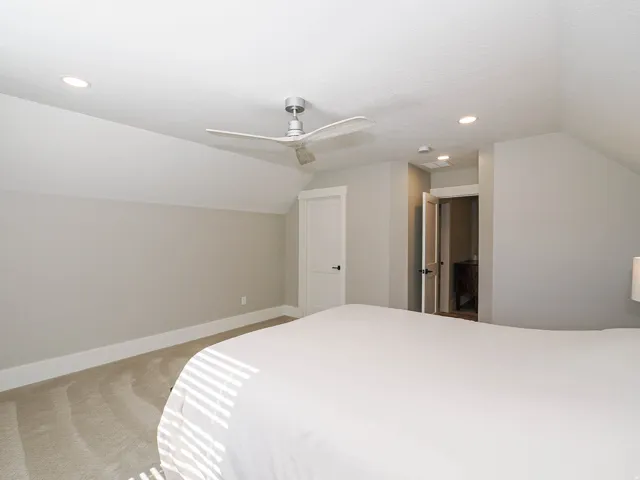 Vaulted ceiling room featuring recessed lighting, a ceiling fan, and light-colored carpeting