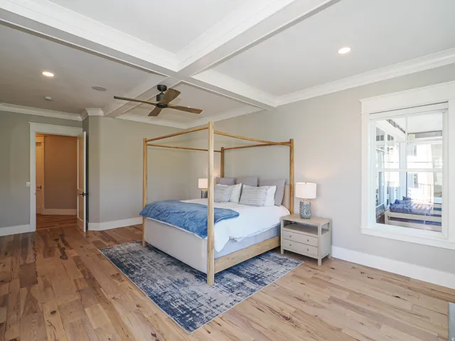 Hardwood flooring featuring a coffered ceiling with recessed lighting