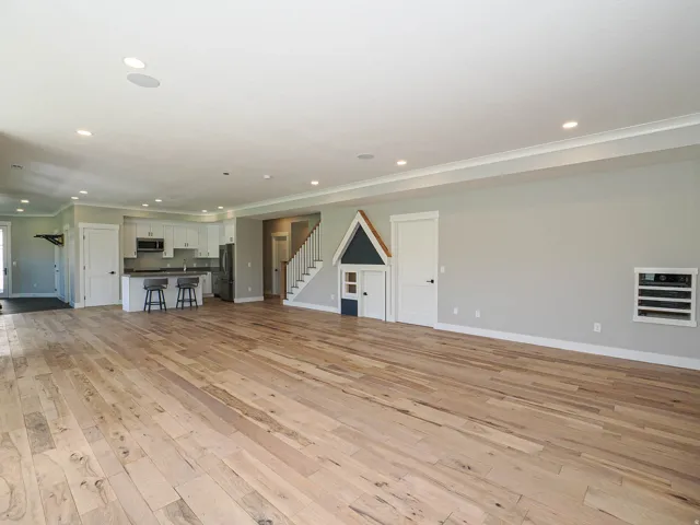 Open-concept living area featuring wide plank wood-finish flooring and recessed lighting throughout
