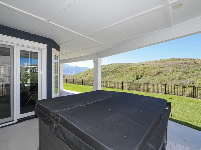 Covered patio with integrated spa, offering expansive outdoor living