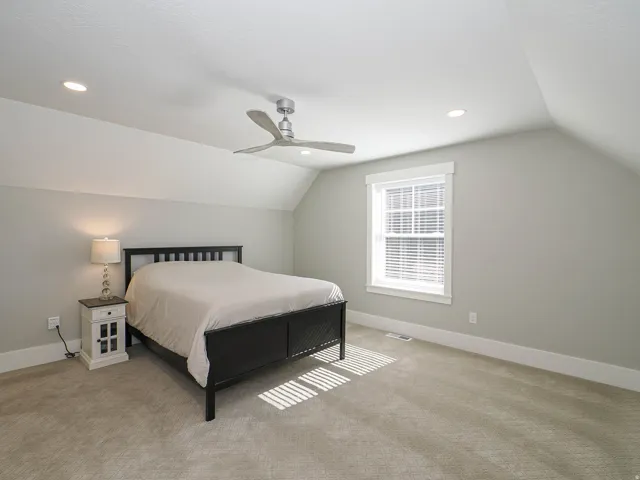 Carpeted room featuring a ceiling fan, recessed lighting, and a window with white blinds