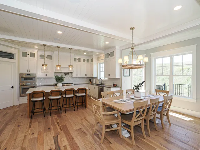 Spacious kitchen and dining area featuring wide-plank wood flooring, recessed lighting, and a shiplap ceiling