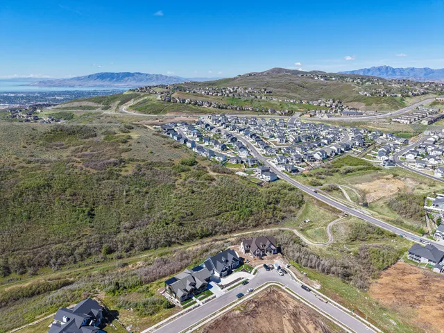Expansive aerial perspective showcasing a developed residential area with additional parcels for development