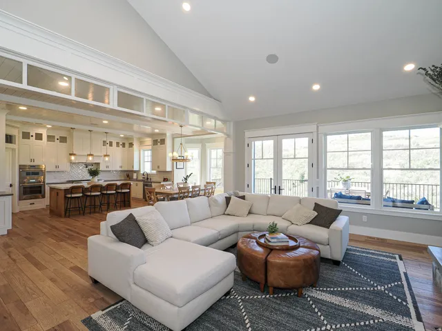 Open-concept living area with vaulted ceilings, hardwood flooring, and recessed lighting