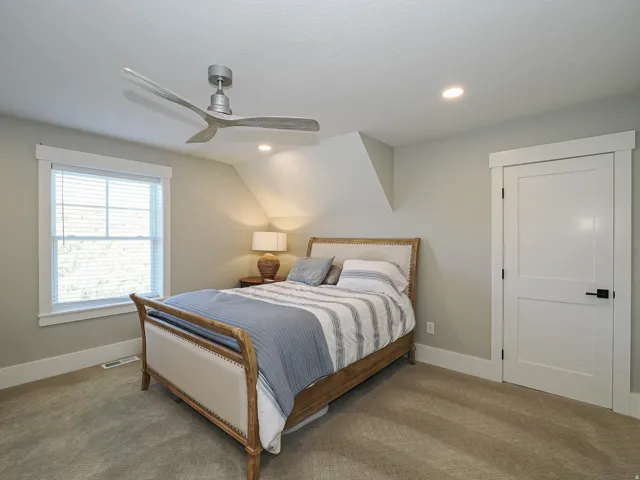 Neutral-toned carpeting extends throughout this room, complemented by light gray walls and white trim