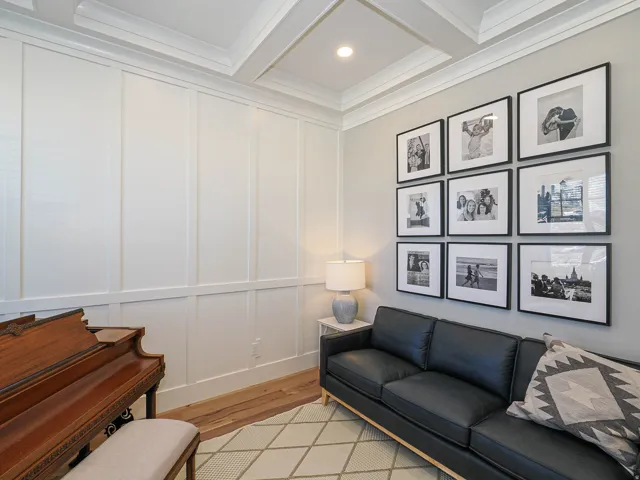 Wainscoting paneling with crown molding, coffered ceiling, recessed lighting, and wood-finish flooring