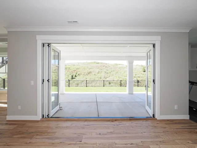 Expansive bifold glass doors opening to a covered patio