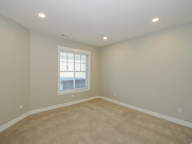 Neutral-toned carpet flooring and walls create a versatile interior space