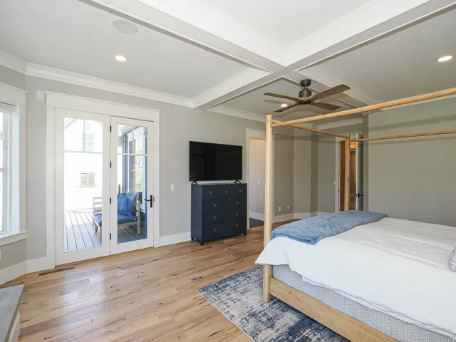 Room featuring wood-finish flooring, a coffered ceiling, a ceiling fan, recessed lighting, and French doors opening to an exterior porch