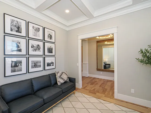 Recessed lighting, crown molding, and coffered ceiling details